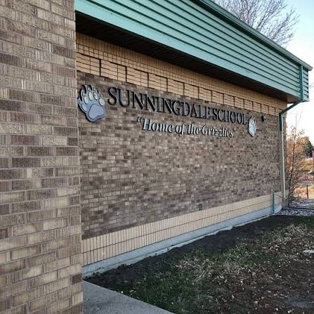 Sunningdale School Grizzlies logo on brick wall
